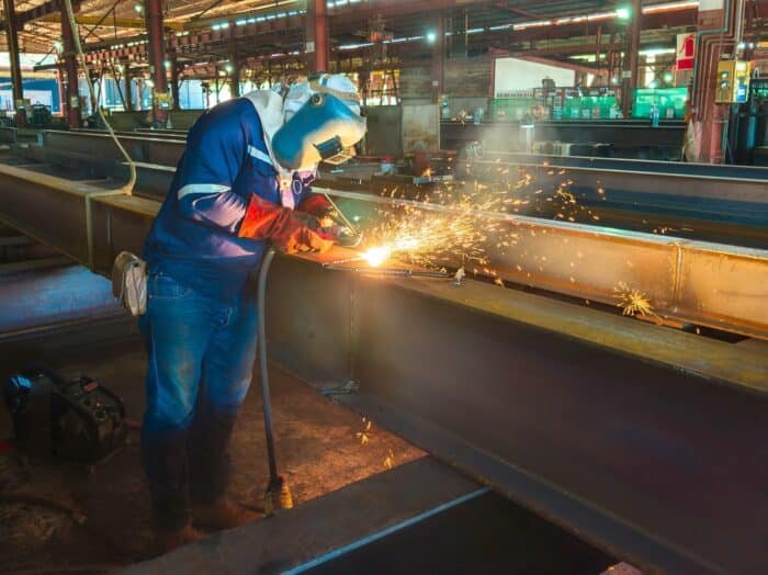 man welding steel